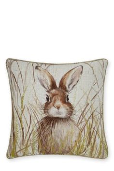 a brown and white pillow with an image of a rabbit