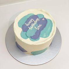 a birthday cake with blue and white frosting