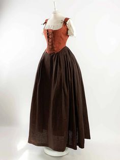 Transport yourself to a bygone era with our Renaissance Costume in Rust Orange and Chocolate Linen. Meticulously handcrafted with meticulous attention to detail, this ensemble is an exquisite choice for Renaissance fairs, Medieval events, or any special occasion where you seek to immerse yourself in history. The rust orange corset, fashioned from premium linen, boasts adjustable straps and a lace-up design that ensures both comfort and a personalized fit. Harmoniously complementing the corset is Brown Peasant Dress, 1600s Dresses Peasant, 1400s Fashion Peasant, 1700s Dresses Peasant, 1600s Fashion Peasant, Fantasy Peasant Dress, Victorian Peasant Dress, Medieval Peasant Clothing, Medieval Corset Dress