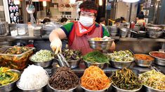 a person wearing a face mask is preparing food