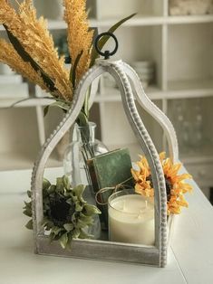 a vase filled with flowers and candles on top of a table