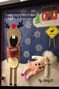 a bulletin board with reindeers and snowflakes on the wall, next to a stuffed animal