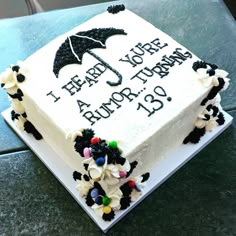 a birthday cake with an umbrella on it