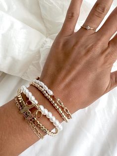 The Bella Stack is the perfect collection of pearls, rhinestones, and bows! Grab a bracelet that shows off your style and make sure to love what you wear! Made with... Length: 7" Clasp: Strechable Metal Finish: Gold Plating To ensure that your bracelet stays to the best of quality, please note to avoid wearing it in water. :) Your order will be shipped carefully with lots of stuffing and love. Don't see the letter your looking for? Message me for a custom order! Stackable Pearl Bangle Bracelet Gift, Adjustable Stackable Pearl Bracelet, White Adjustable Stackable Pearl Bracelet, White Stackable Adjustable Pearl Bracelet, Luxury Stackable Gold-plated Bracelet, Pearl Bracelet Stack, Jewelry Coquette, Pearls Jewelry, Stack Bracelet