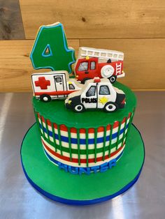 a birthday cake with cars and trucks on it