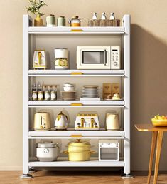 a white shelf filled with lots of different types of dishes and microwaves on top of it