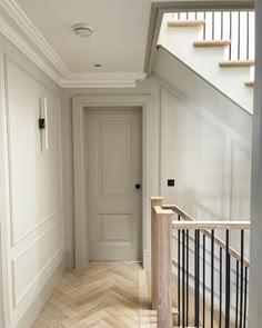 an empty hallway with white walls and wood flooring on the bottom level is seen in this instagram