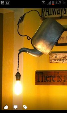 there is a metal watering can hanging from the wall