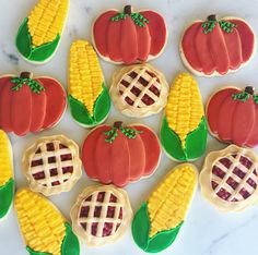 decorated cookies arranged in the shape of pumpkins and corn