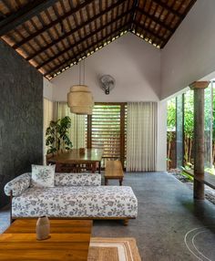 a living room filled with furniture and windows