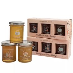 four jars of honey sitting next to each other