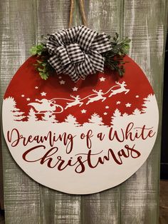 a wooden sign that says dreaming of a white christmas with santa's sleigh