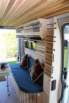 the interior of a camper with bunk beds and built - in desks is shown