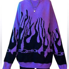 a purple sweater with black and white designs on it