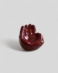 a small red object sitting on top of a white surface