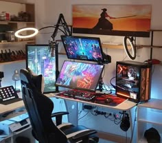 a computer desk topped with two monitors next to a keyboard and mouse on top of a chair