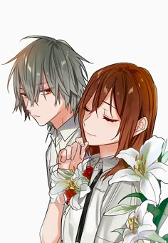 two people are hugging each other with flowers in front of them