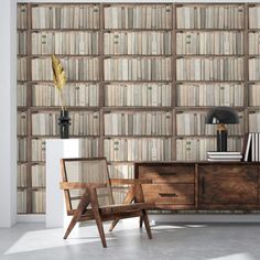 a chair sitting in front of a bookshelf filled with lots of bookcases