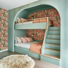 a bedroom with bunk beds and floral wallpaper