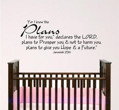 a baby crib with a bible verse on the wall