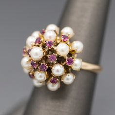 "Gorgeous Vintage Ruby and Pearl Tiered Princess Harem Ring in 18k Yellow Gold Pretty sparkling red rubies and luminous pearls alternate rows in this gorgeous princess or harem ring.  The pearls measure about 4mm on average while the rubies measure on average 2mm, totaling about 0.25cttw.  The ring is not for the faint of heart at height- it measures about 1/2\" off of the finger, however the components are so feminine that it doesn't seem overly bold.  This ring is crafted in 18k and weighs 5.5 Vintage Pearl Rings, Harem Rings, Rajput Jewellery, Antique Ruby Ring, Ruby And Pearl, Antique Gold Rings, Pearl Rings Vintage, Ruby Ring Vintage, Gemstone Rings Vintage