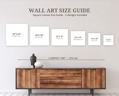 the wall art size guide is displayed in front of a wooden cabinet with three white square frames