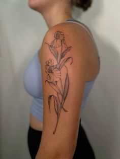 a woman with a flower tattoo on her arm