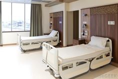 an empty hospital room with two beds in the middle and one on the other side