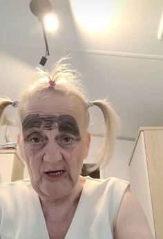 an old woman with makeup on her face