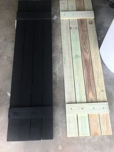 two pieces of wood sitting next to each other on top of cement flooring area