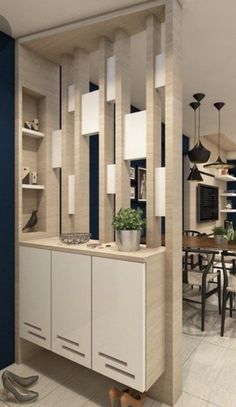 a dining room with blue walls and white cabinets