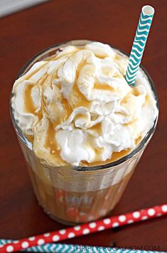 there is a cup with whipped cream and a straw in it