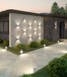 a modern house with lights on the front