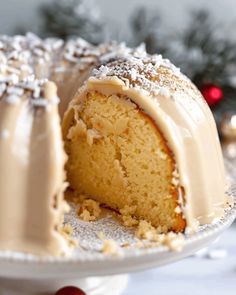 a bundt cake with frosting and sprinkles sits on a plate