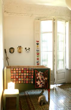 a living room filled with lots of furniture and decor on top of tile flooring