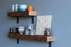 two wooden shelves with metal brackets holding cups and mugs on top of each shelf