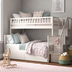 a white bunk bed sitting next to a window in a child's room on top of a wooden floor