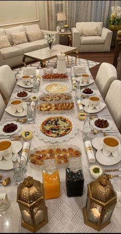 a long table is set with food and drinks for two people to eat at the same time