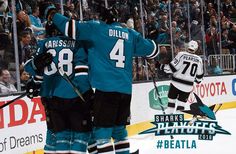 two hockey players standing next to each other in front of an ice rink full of people