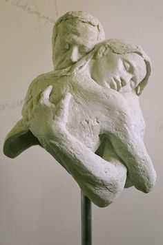 a sculpture of a woman holding a man in her arms