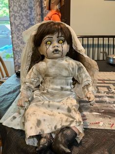 a creepy doll sitting on top of a table