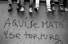 five people sitting on a wall with graffiti written on it and the words'avuse mato yse torturo'in spanish