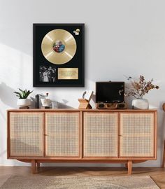 an old record player is sitting on top of a sideboard in the living room