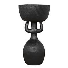 a black vase sitting on top of a white background