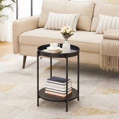 a living room with a couch, coffee table and books