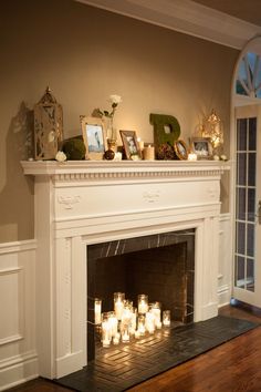 a fireplace with lit candles in front of it