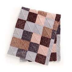 a brown and white checkered blanket on top of a white surface with no one in it