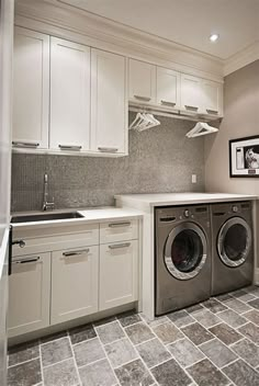 a washer and dryer sitting in a kitchen next to a counter top oven