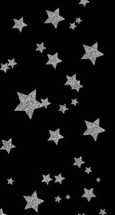 silver glitter stars are flying in the air