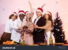 group of people celebrating christmas with champagne glasses